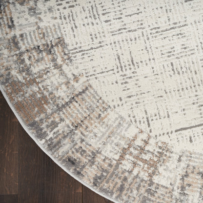 Abstract cream-gray rug with tan accents and curved edge on dark wood floor.