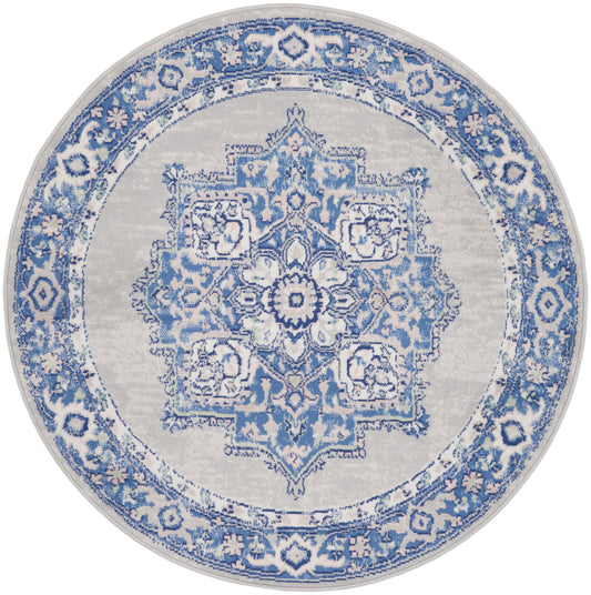 Round blue-and-white oriental rug with intricate central medallion and floral border.
