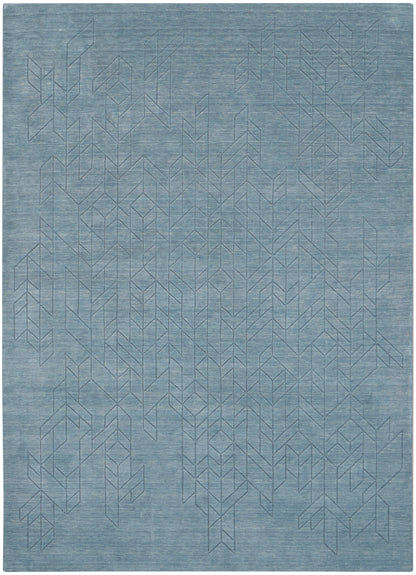 Blue-gray woven rug with a subtle geometric chevron line pattern; soft, textured, rectangular floor covering.