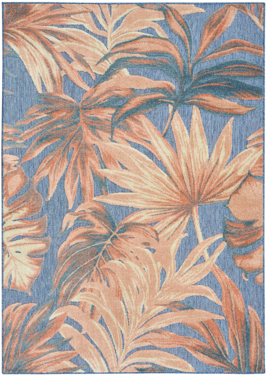 Rectangular area rug with peach tropical palm leaves on a blue woven background.