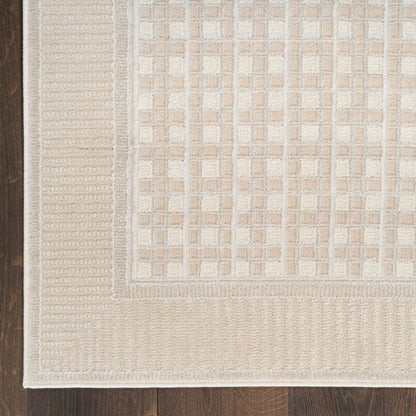 Beige rectangular woven rug with cream grid pattern and ribbed border on dark hardwood floor.