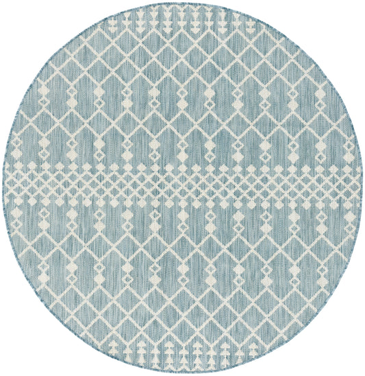 Round light-blue rug with white geometric lattice diamonds; modern coastal decor.