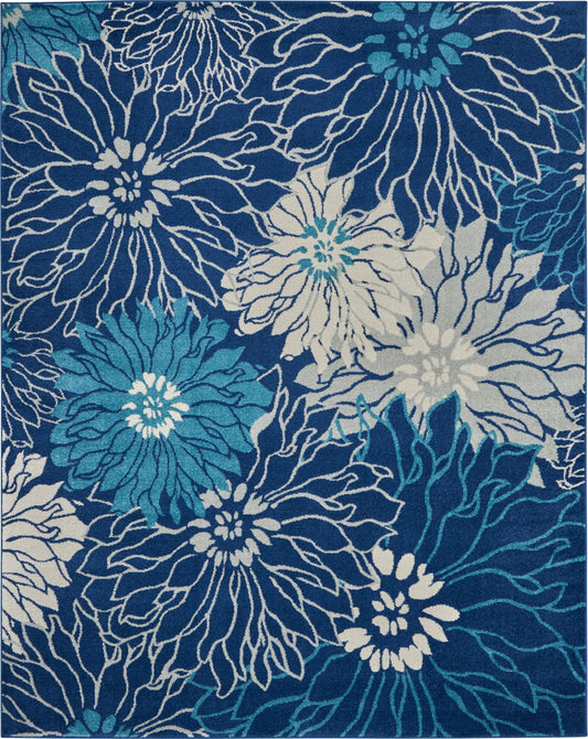 Rectangular woven rug with navy backdrop and large teal, turquoise and white floral pattern.