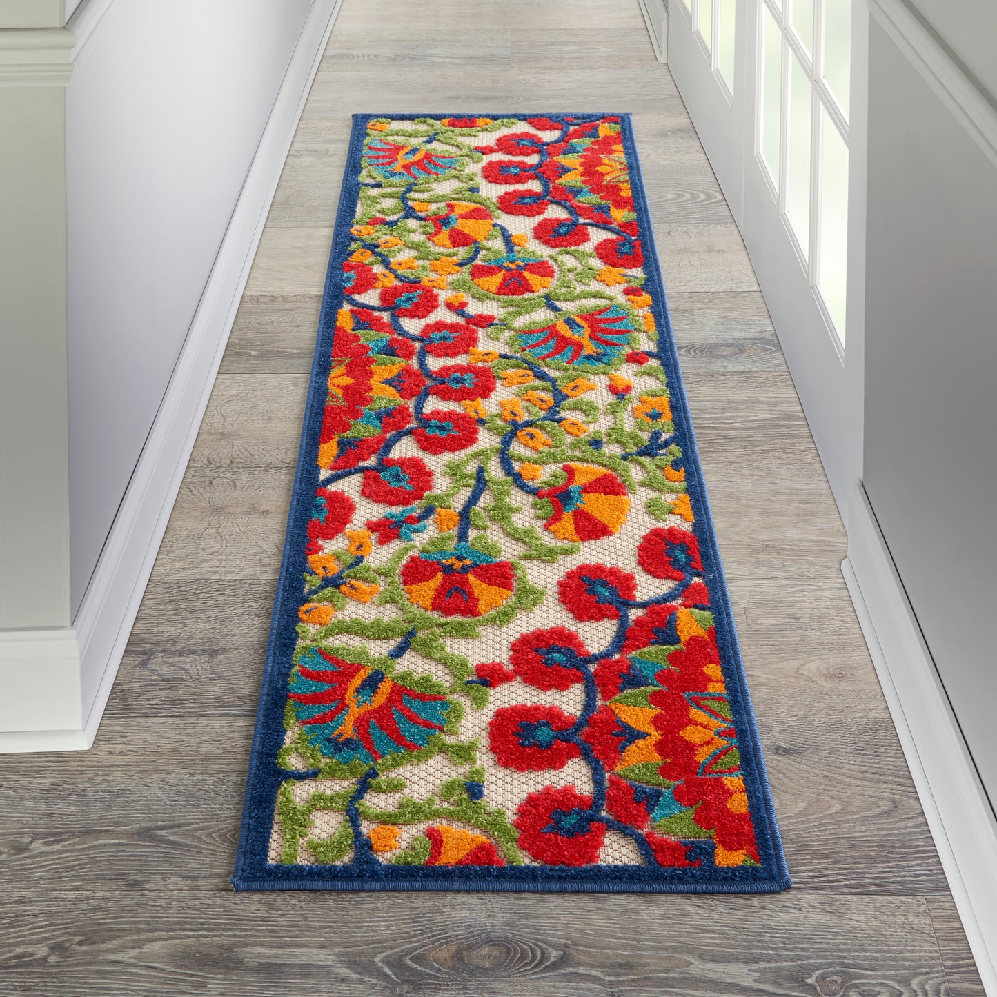 Colorful floral runner rug with red, yellow, blue & green flowers on cream, blue border, rectangular hallway mat.