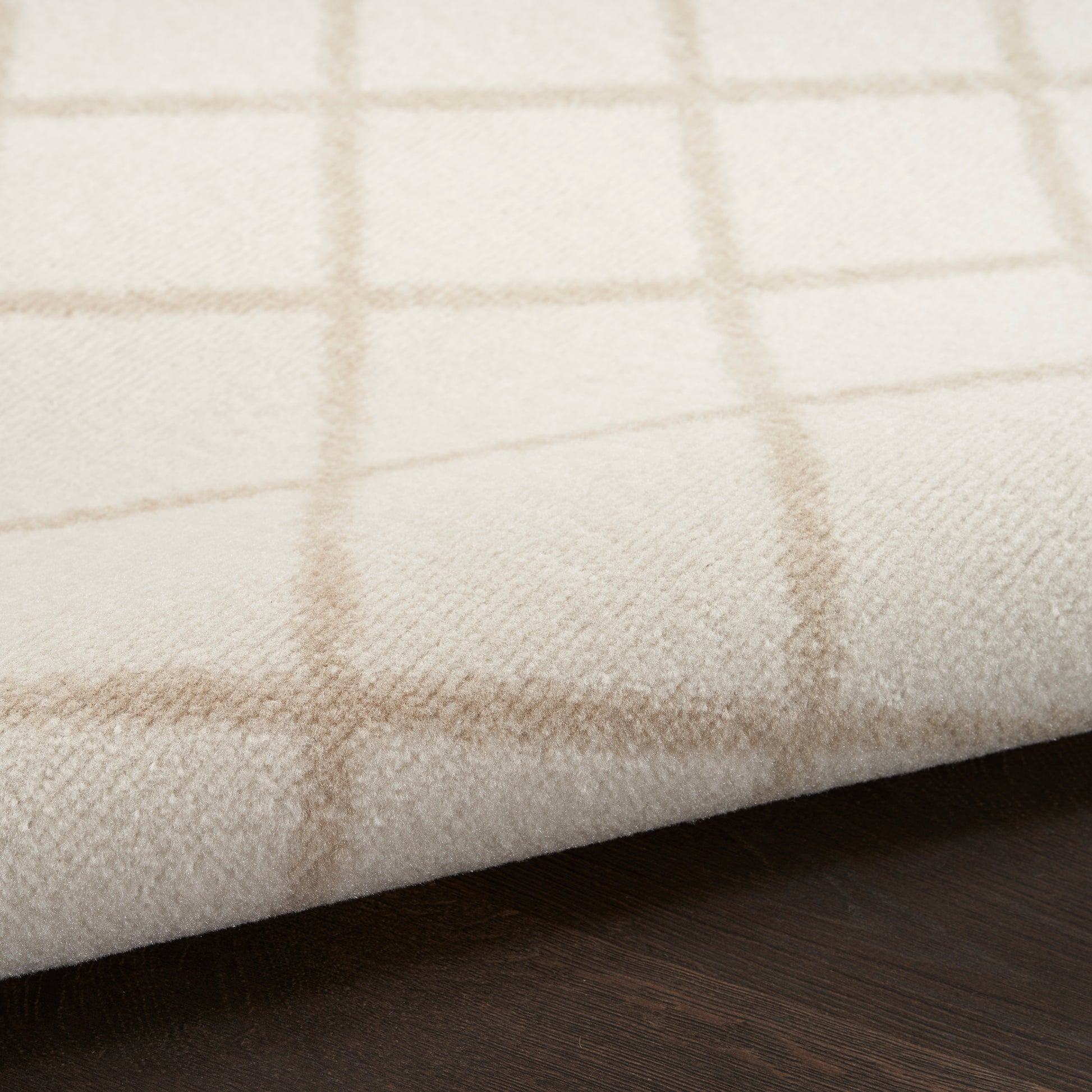 Cream plaid Bohemian 6' runner rug with light brown grid lines, soft woven texture on a dark wood surface.
