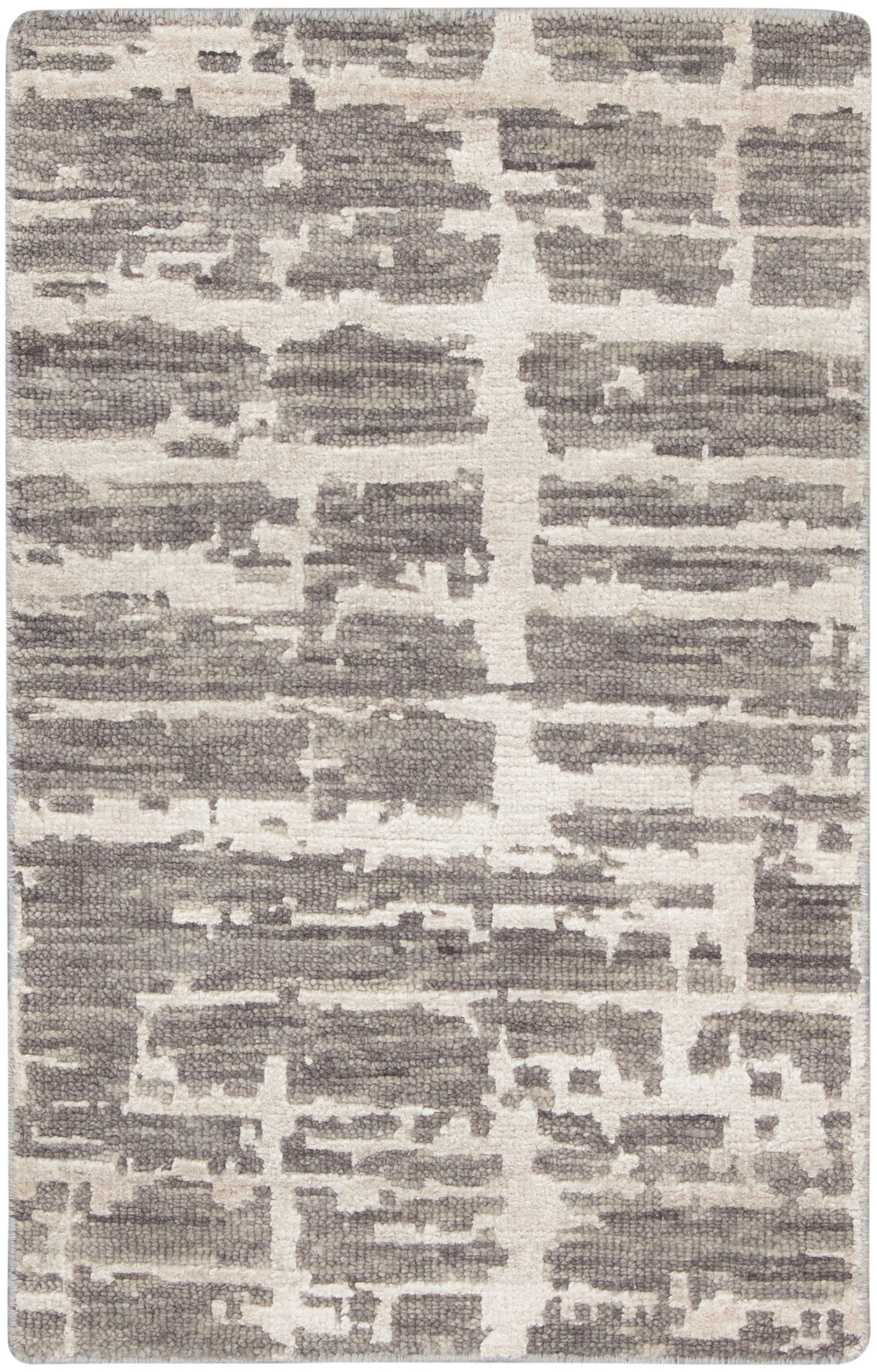 Rectangular rug in gray and ivory with an abstract block pattern; woven texture, contemporary floor decor.