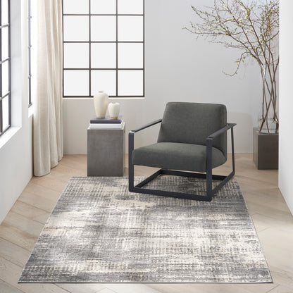 Modern gray rug, 5' x 7', in a bright minimalist living room.