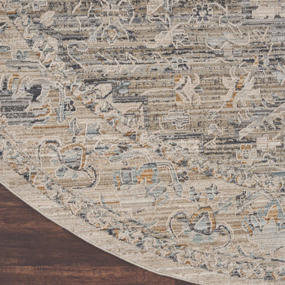 8' round oriental-style rug in beige, ivory, and blue with a distressed floral pattern on a dark wood floor.