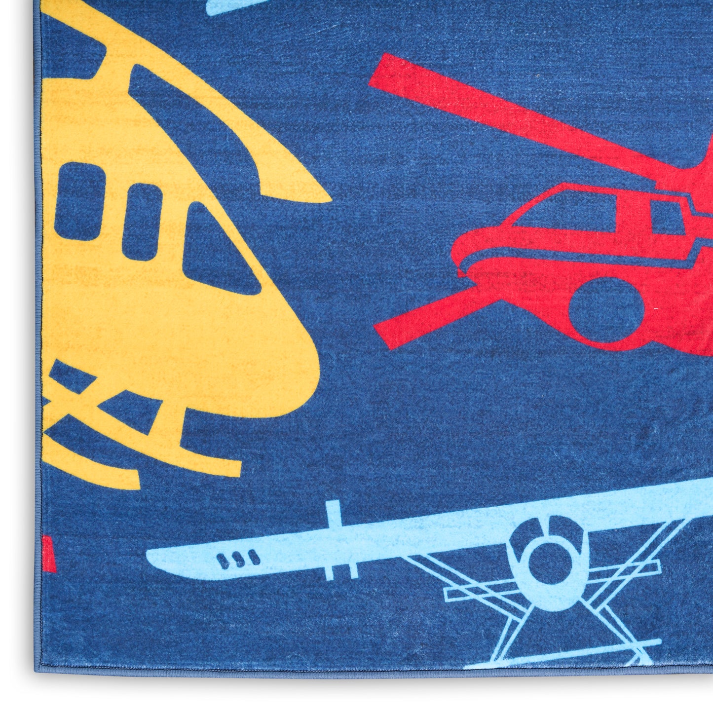 Blue kid’s rug with bold yellow helicopter, red helicopter and light-blue airplane silhouettes.