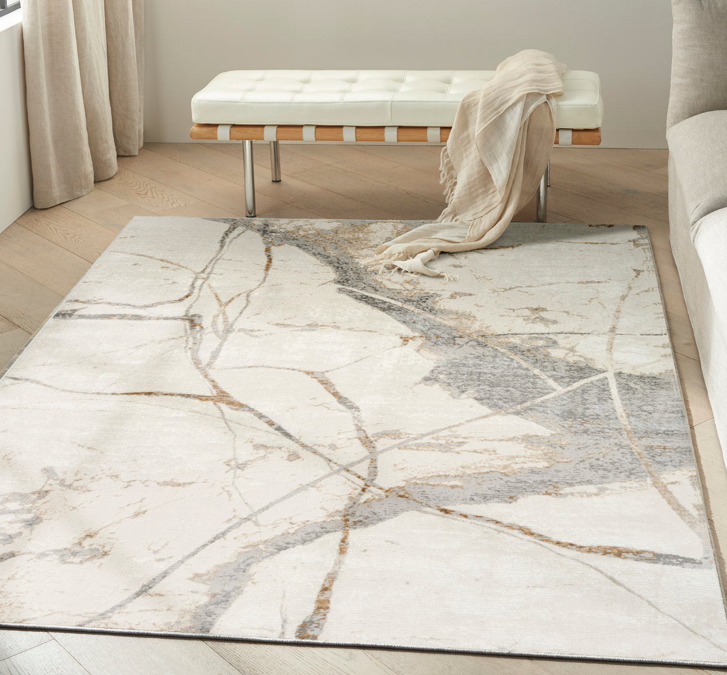 Cream ivory area rug with abstract gray and taupe marble veining for a modern living room.