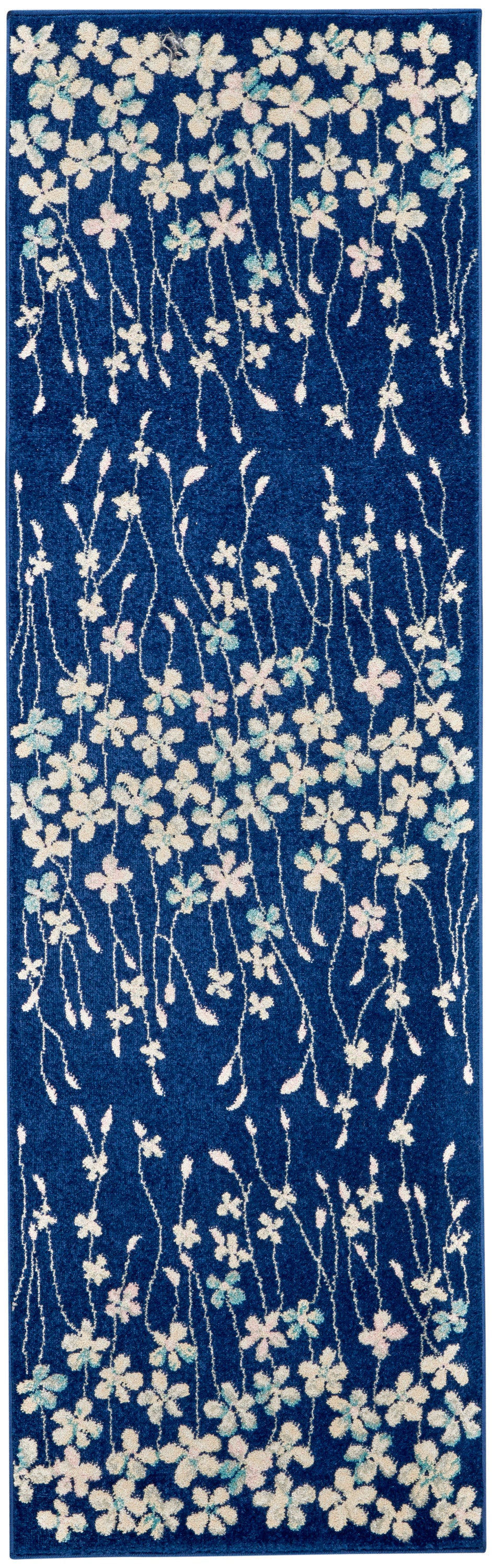 Blue floral runner rug with white and pastel blossoms on twisting stems; long hallway mat with plush textured pile.