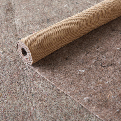 Rolled tan woven rug with a small waffle texture.
