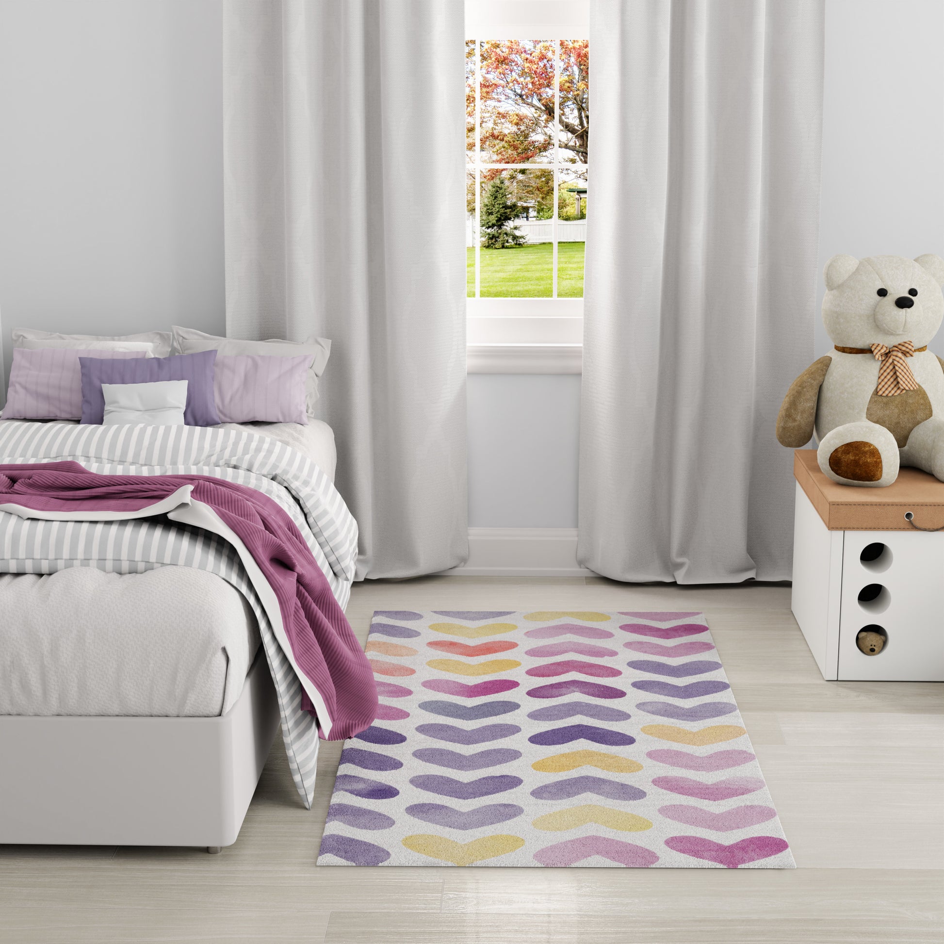 Pastel kids' bedroom: gray bed, striped bedding, pink throw, colorful teardrop rug, teddy bear on white nightstand.