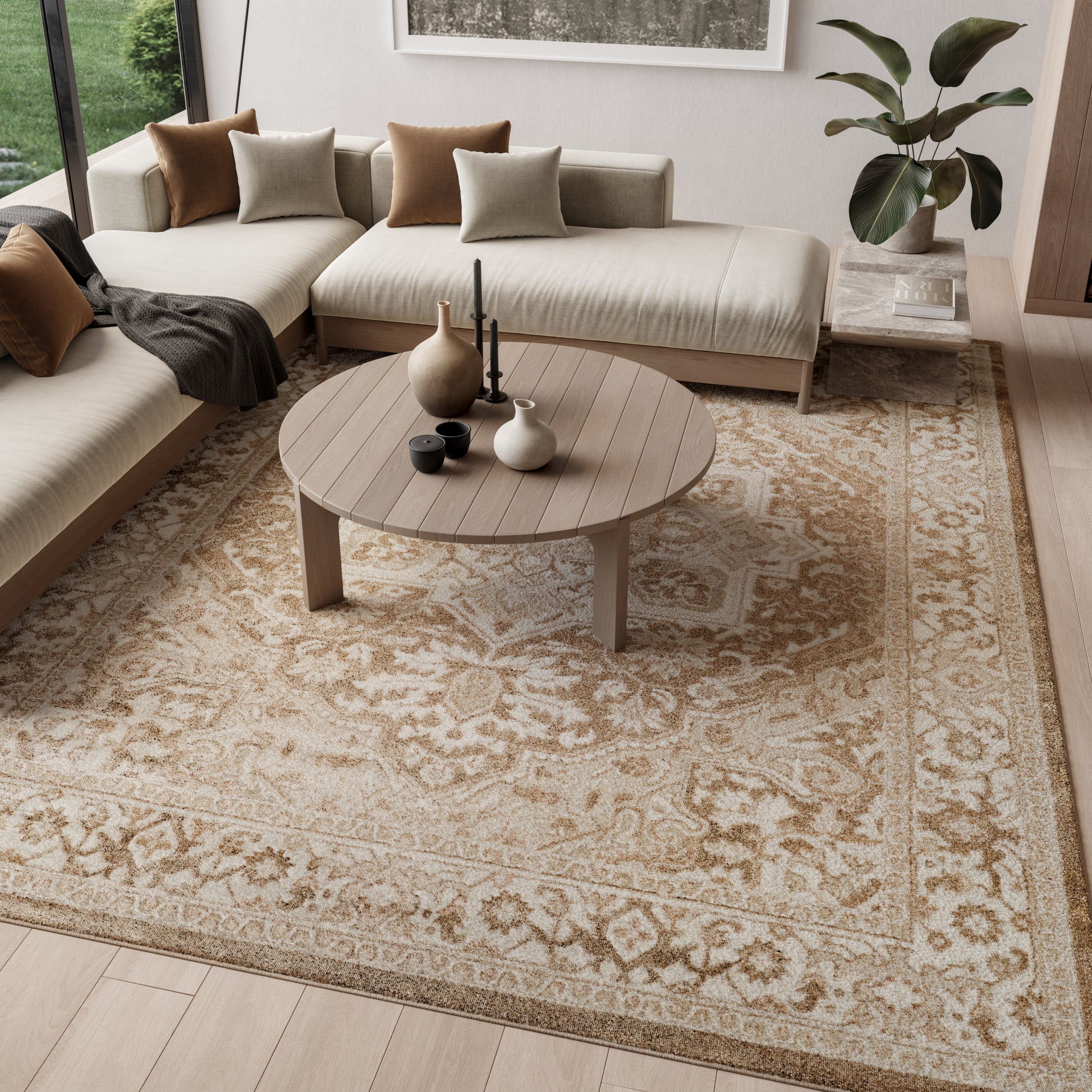 8' x 10' vintage beige patterned rug in a living room with a neutral L-shaped sofa, cushions, plant, and decorative vases.