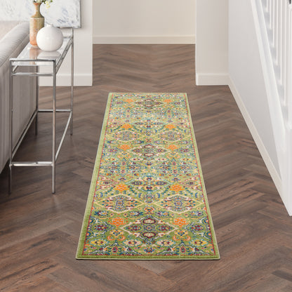 Vibrant oriental-style hallway runner rug with lime-green border on dark wood herringbone floor by a metal console table.