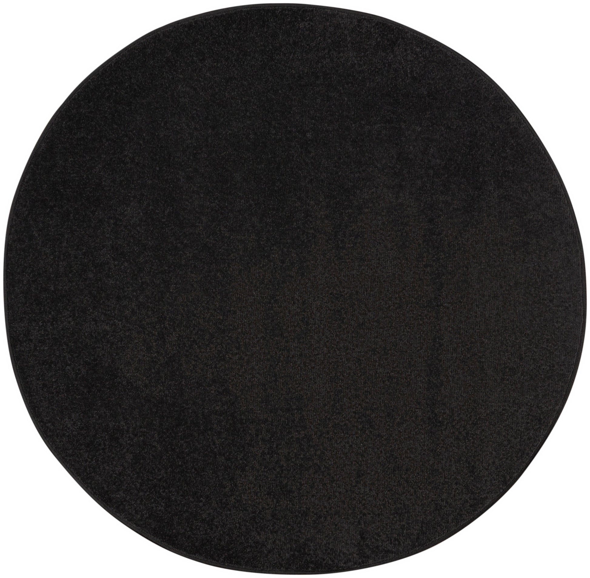 Round black felt circle with textured surface, minimalist placemat.