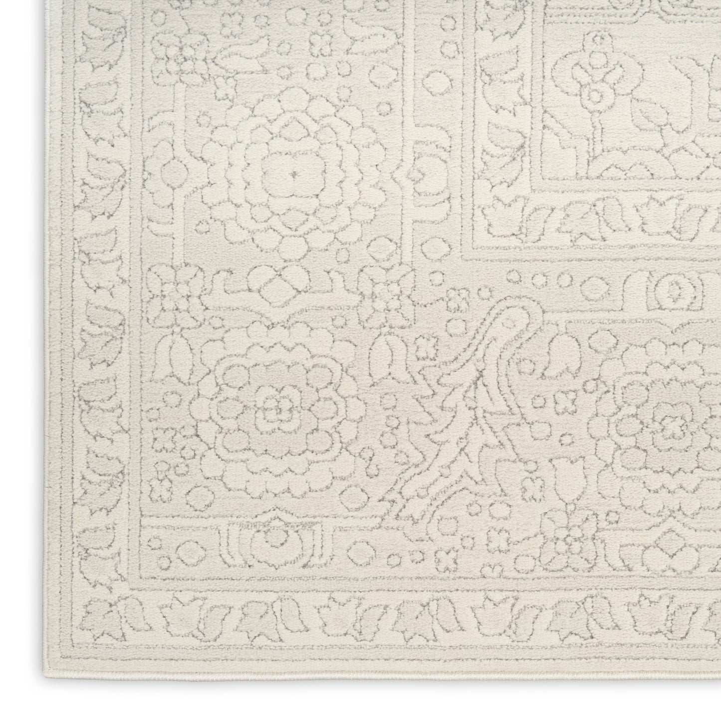 Cream ivory rug with embossed floral medallions and decorative border; Persian-inspired floor covering.