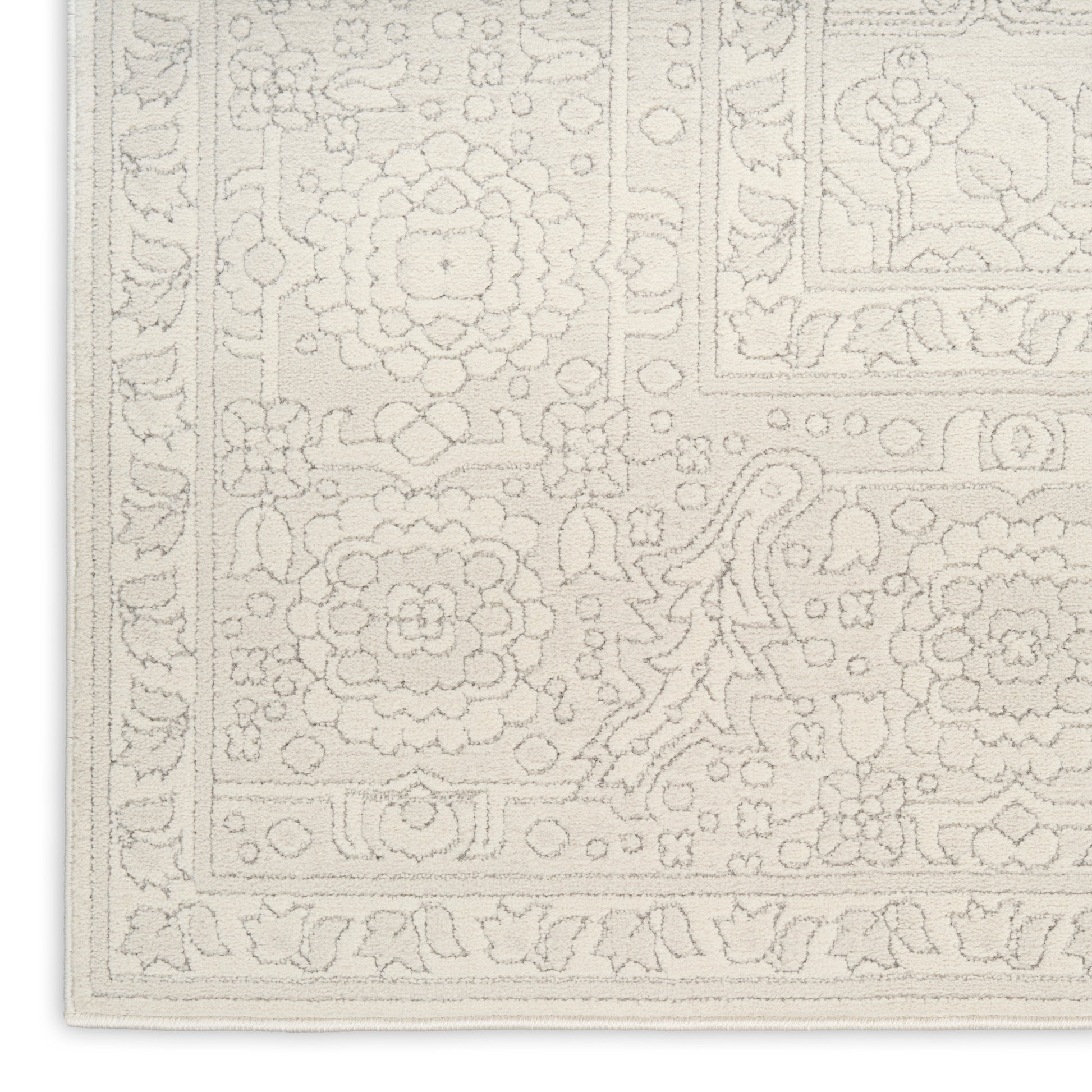 Cream ivory rug with embossed floral medallions and decorative border; Persian-inspired floor covering.