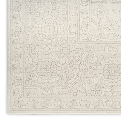 Cream ivory rug with embossed floral medallions and decorative border; Persian-inspired floor covering.