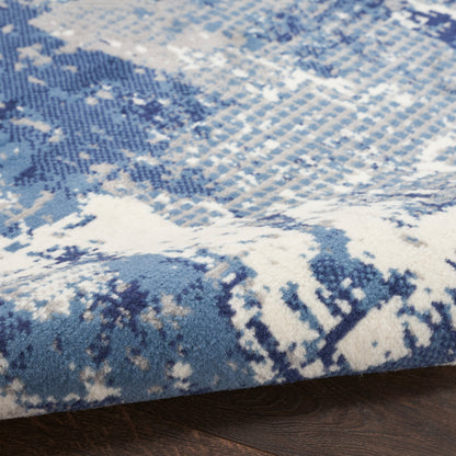 Blue and white abstract runner rug with textured pile on dark wood floor.