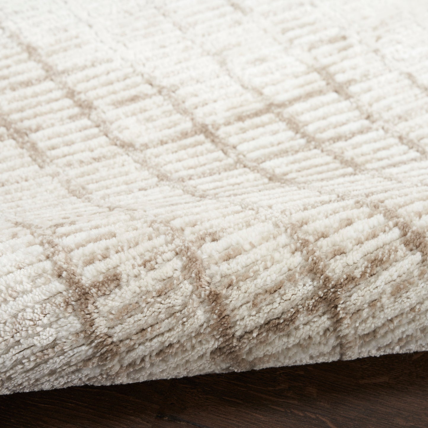 Cream shag rug with subtle beige stripes; plush, soft texture for cozy indoor floors.