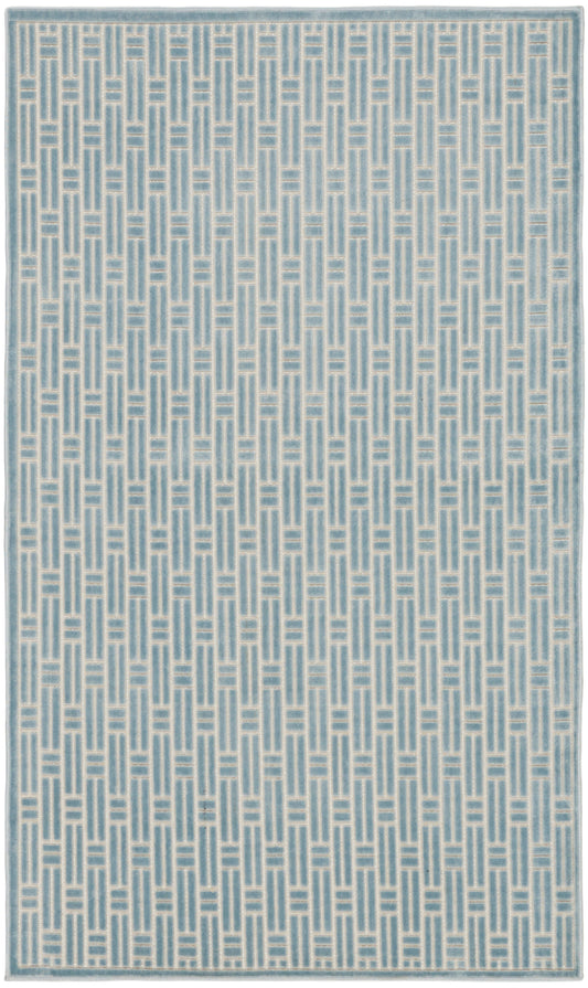 Blue woven rug featuring a white ladder-patterned geometric weave and a pale border.