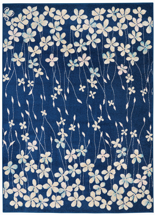 Navy blue rug with white and pastel flowers on long twisting stems.