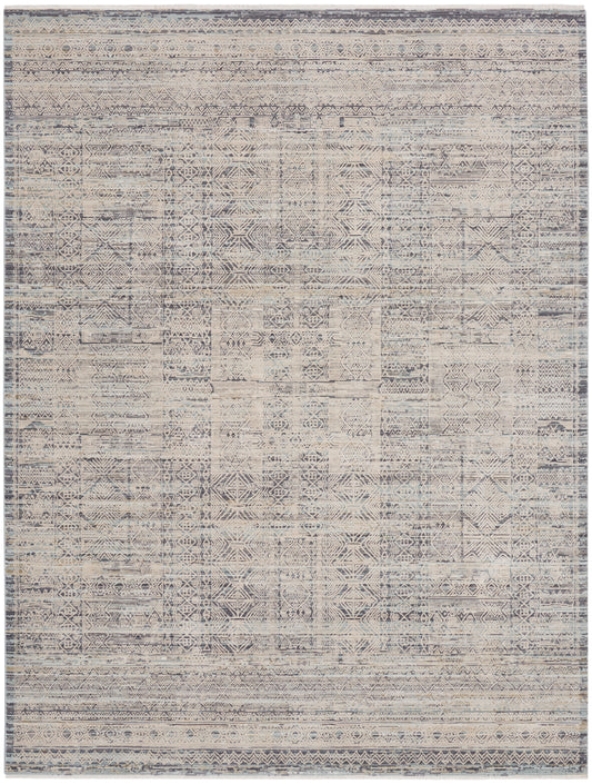Distressed flatweave rug with geometric tribal motifs in beige, gray & blue tones and a bordered edge.