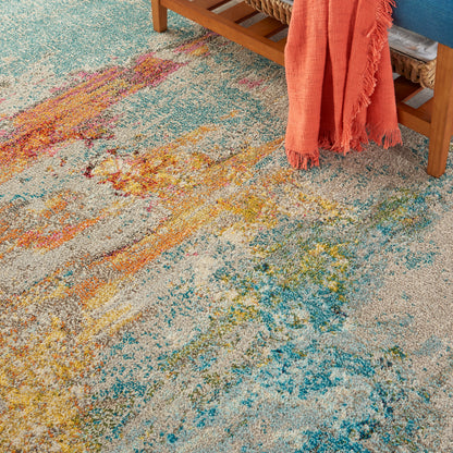 Abstract multicolor area rug with teal, blue, yellow and orange tones; textured plush pile, modern boho style.