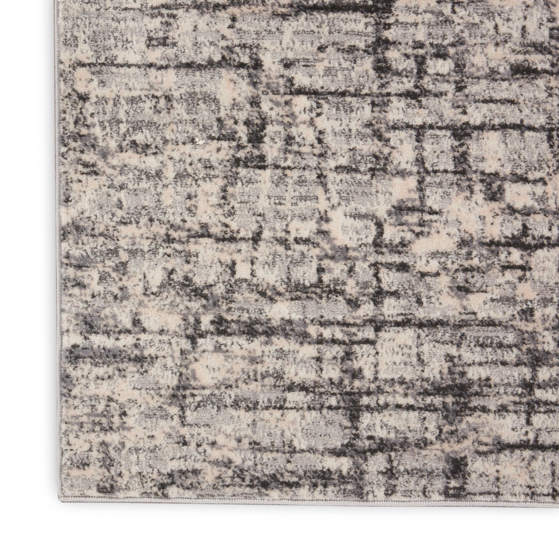 Rectangular beige-gray distressed abstract patterned area rug with textured fibers and a light border.