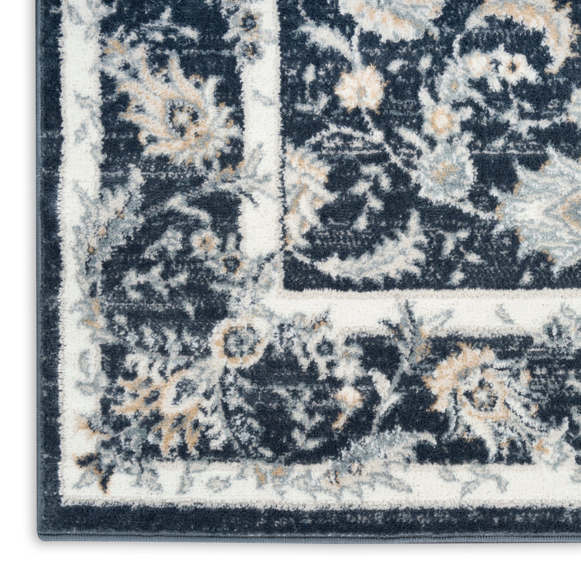 Rectangular navy oriental rug corner with ivory border and cream floral motifs.