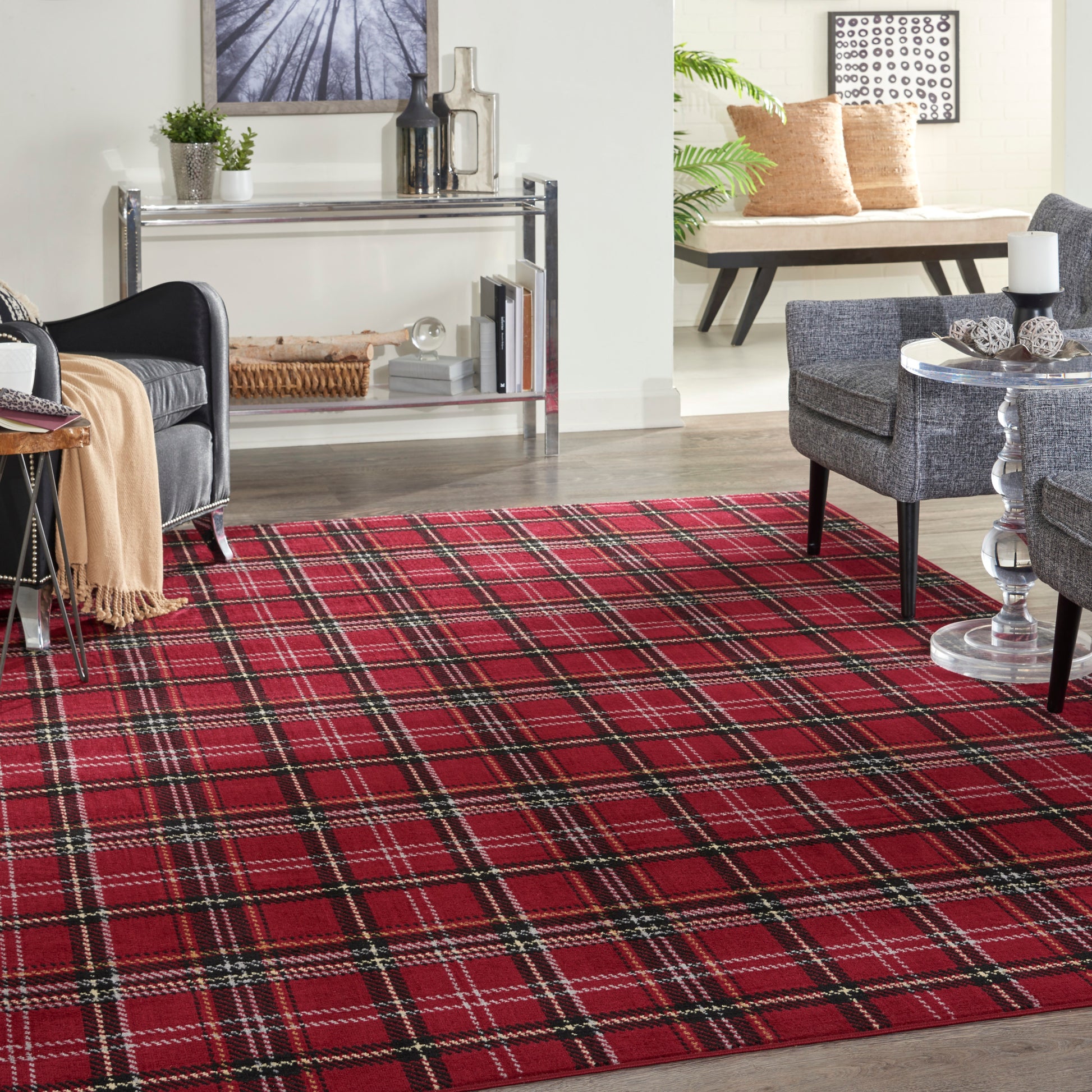 Red plaid rug in contemporary living room; gray upholstered chairs, chrome/glass console, glass tables, beige throw.