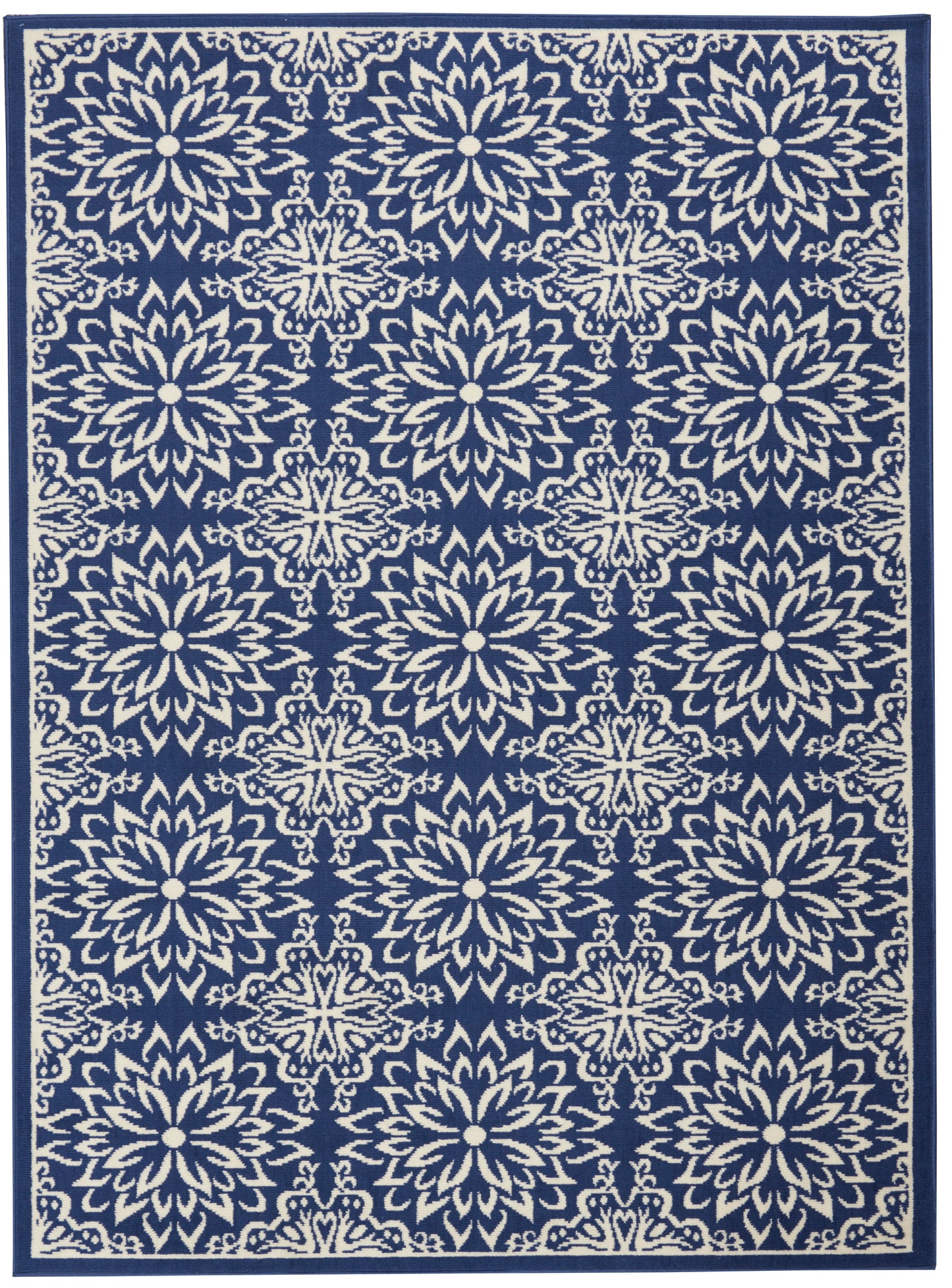 Navy blue rug featuring repeating ivory floral medallion lattice pattern with dark border.