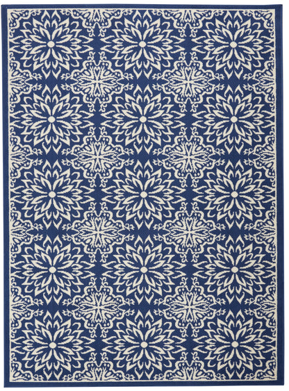 Navy blue rug featuring repeating ivory floral medallion lattice pattern with dark border.