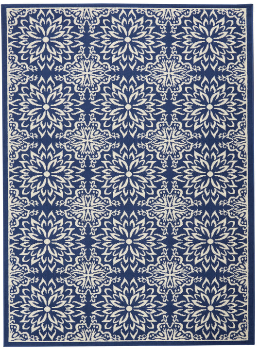 Navy blue rug featuring repeating ivory floral medallion lattice pattern with dark border.