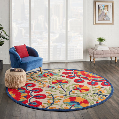 8' round floral rug with a blue border on dark wood floor.