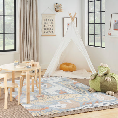 Kids' playroom with a white fabric teepee, orange cushion, light wood table and chairs, pastel geometric rug, and green animal beanbags.