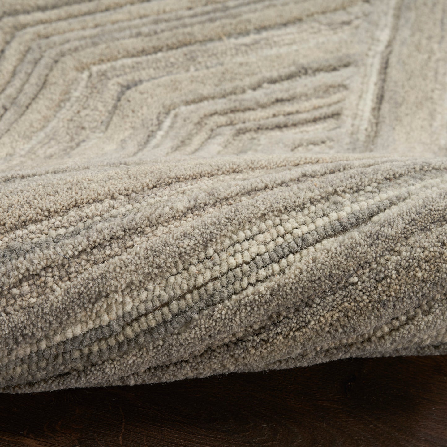 Beige textured rug with raised geometric stepped lines and soft looped pile, cozy home decor.