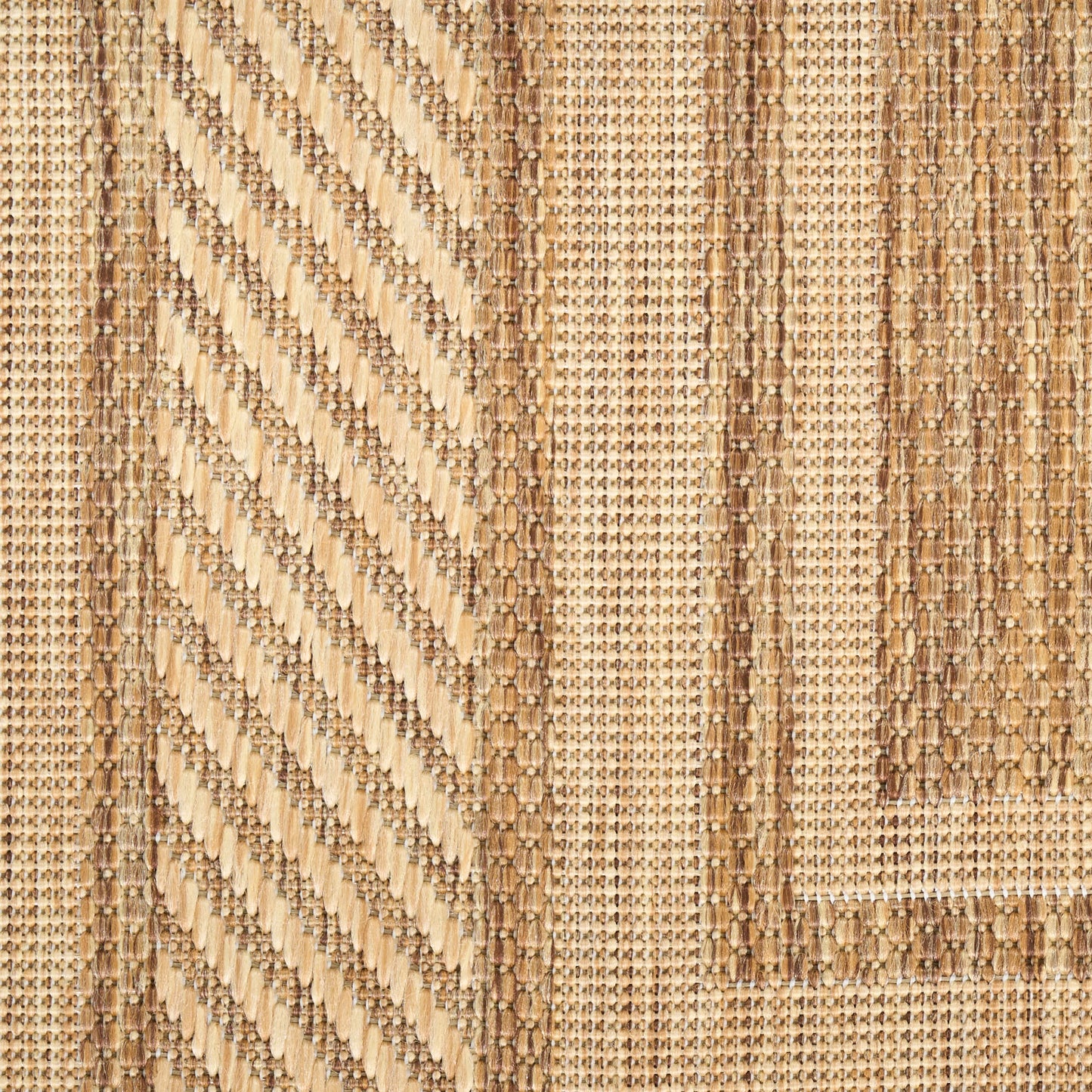 Natural jute rug with diagonal chevron panels and tan-brown striped borders in a woven geometric pattern.