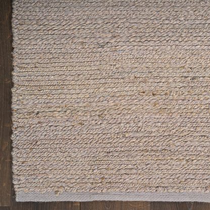 Beige natural jute rug, looped texture with light gray binding, farmhouse-style area rug.