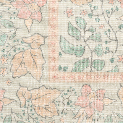 Pastel floral rug pattern with peach and mint leaves, pink flowers on cream, framed by a decorative border and woven texture.