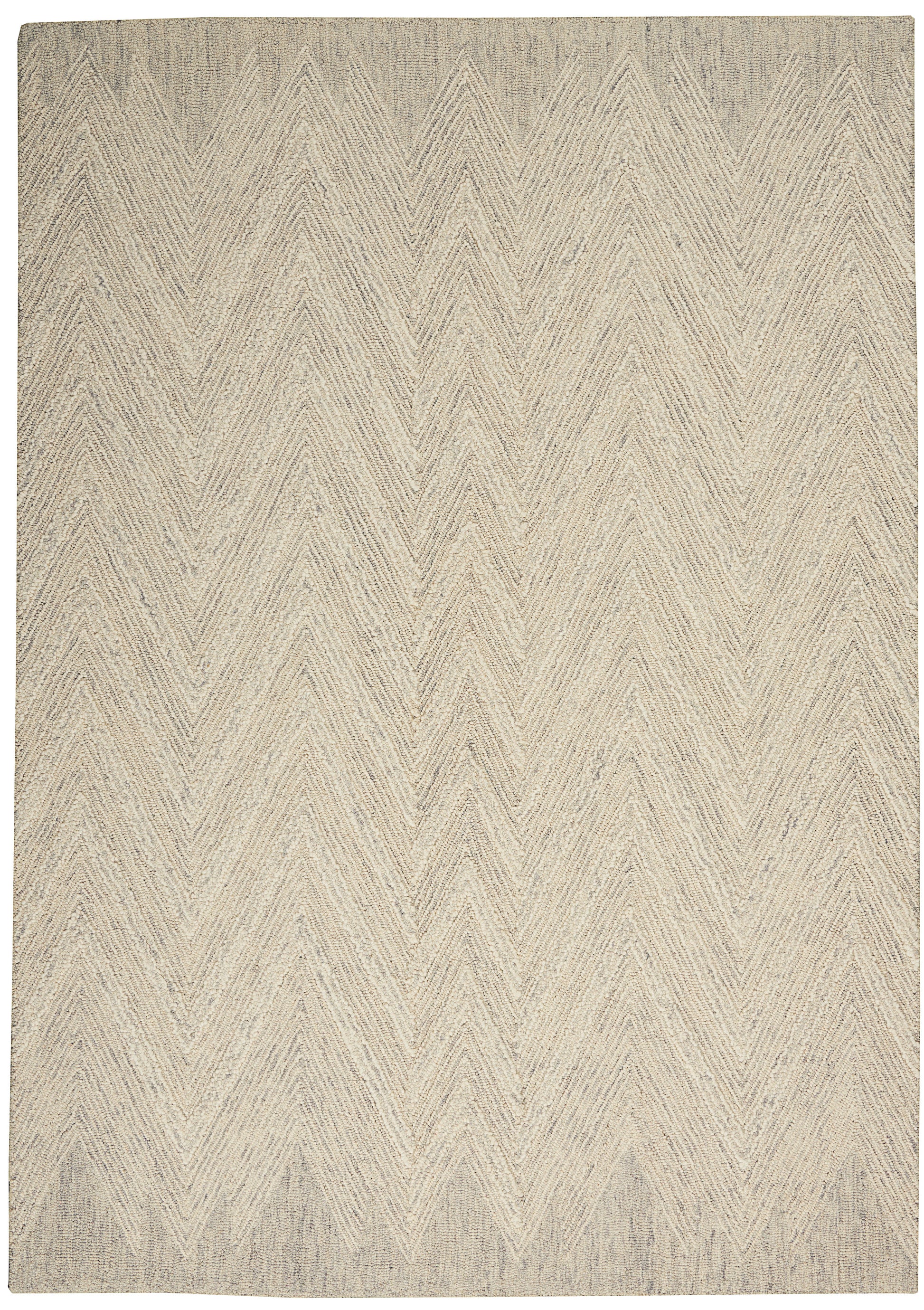 Beige chevron-patterned woven rug in natural fibers; rectangular and neutral for living spaces.