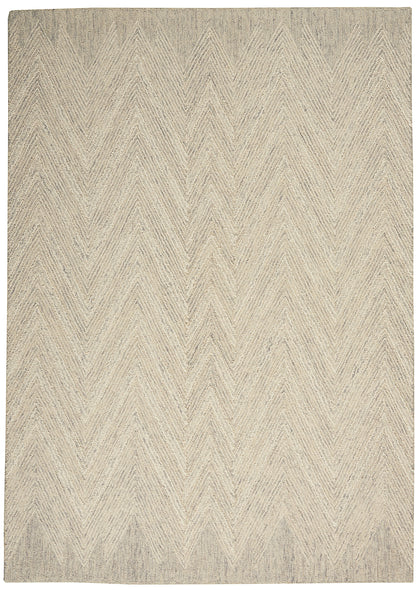 Beige chevron-patterned woven rug in natural fibers; rectangular and neutral for living spaces.