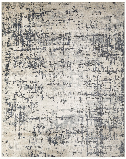 Abstract distressed area rug in beige and gray tones with charcoal speckled pattern.