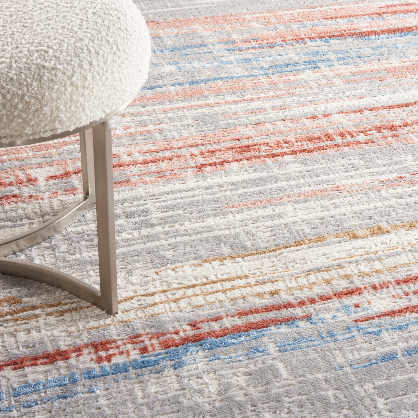 9' x 12' modern rug with orange, blue, beige, and gray stripes.