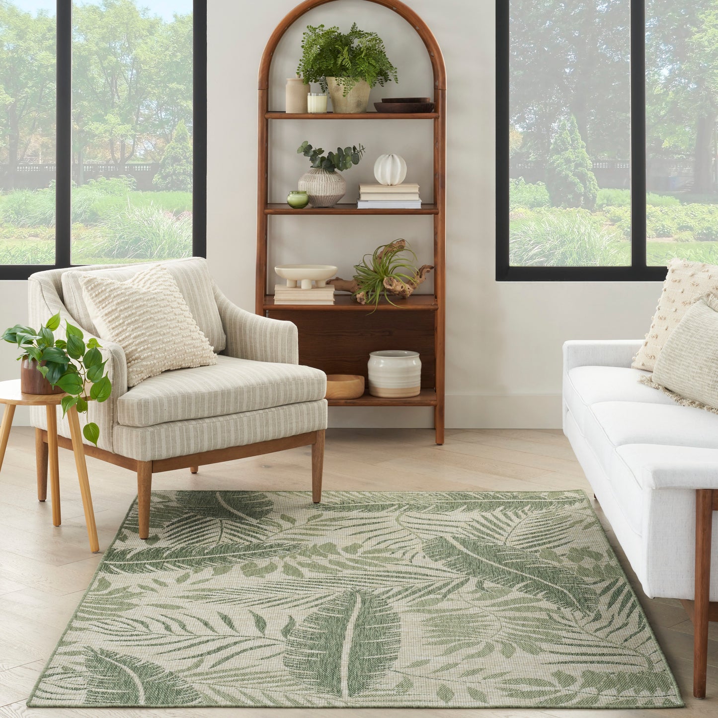 Outdoor rug with a green botanical pattern, 5' x 7'.