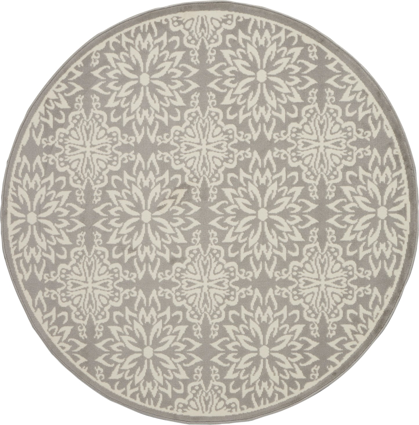 Round taupe rug with cream ornate repeating floral starburst pattern; decorative, modern-traditional style.