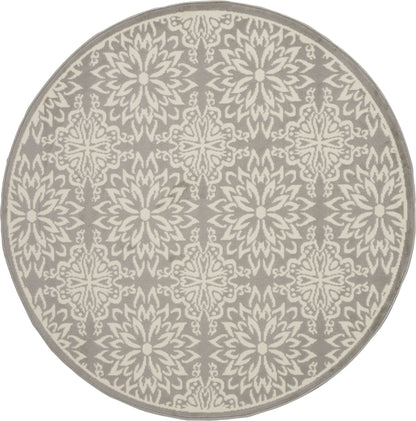 Round taupe rug with cream ornate repeating floral starburst pattern; decorative, modern-traditional style.