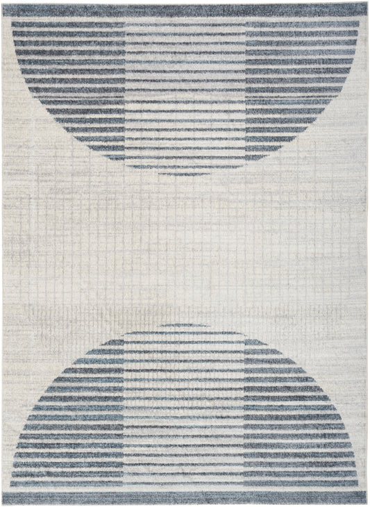 Beige rug featuring two large blue striped semicircles, forming a symmetrical geometric design.