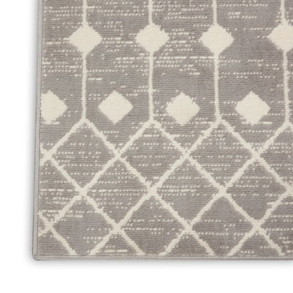 Gray rug with white diamond lattice pattern and small diamond accents; modern geometric floor decor.